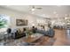Spacious living area featuring a fireplace, modern decor, wood floors, and an open layout leading to the kitchen at 702 Beacon Hill Rd # 51, Lillington, NC 27546