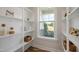 Organized pantry with white shelving and window view to the front yard at 702 Beacon Hill Rd # 51, Lillington, NC 27546