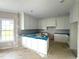 New kitchen with crisp white cabinets, backsplash, and spacious countertop area, ready for personalization at 7491 Sweetwater Dr, Nashville, NC 27856
