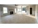Open-concept living room with fireplace and access to the kitchen, primed for customization and comfortable living at 7491 Sweetwater Dr, Nashville, NC 27856