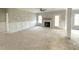 Bright living room with a fireplace, ceiling fan, wainscoting, and large windows, awaiting finishing touches at 7491 Sweetwater Dr, Nashville, NC 27856