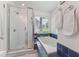 Bright bathroom features a shower, soaking tub, and window, creating a serene and inviting space at 7804 Tylerton Dr, Raleigh, NC 27613