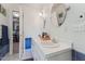 Bathroom with double sinks, vanity with storage, tile accents, and walk-in closet at 7804 Tylerton Dr, Raleigh, NC 27613