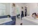 Bright bathroom with a soaking tub, tiled accents, and a walk-in closet at 7804 Tylerton Dr, Raleigh, NC 27613