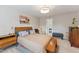 Comfortable bedroom with neutral walls, natural light, and access to the bathroom at 7804 Tylerton Dr, Raleigh, NC 27613
