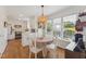 Bright breakfast nook features a round table, hardwood floors, and a modern light fixture and décor at 7804 Tylerton Dr, Raleigh, NC 27613