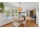 Bright breakfast nook features a round table, hardwood floors, large windows, and views of the backyard at 7804 Tylerton Dr, Raleigh, NC 27613