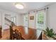 Cozy dining room with wood floors, large windows, decorative light fixture, and stylish decor at 7804 Tylerton Dr, Raleigh, NC 27613