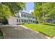 Traditional two-story home features a driveway, attached garage, and a well-maintained lawn with mature trees at 7804 Tylerton Dr, Raleigh, NC 27613