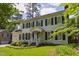 Elegant home with manicured lawn and lush landscaping offers great curb appeal at 7804 Tylerton Dr, Raleigh, NC 27613