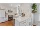 Bright and modern kitchen featuring white cabinets, quartz countertops, stainless steel appliances, and hardwood floors at 7804 Tylerton Dr, Raleigh, NC 27613