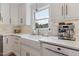 Well-lit kitchen with white cabinetry, subway tile backsplash, a farmhouse sink, and stainless steel appliances at 7804 Tylerton Dr, Raleigh, NC 27613