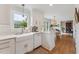 The kitchen features modern appliances, white countertops, and a large window for plenty of natural light at 7804 Tylerton Dr, Raleigh, NC 27613