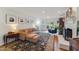 Sun-drenched living room with hardwood floors, a comfortable couch, fireplace, and doors to the backyard at 7804 Tylerton Dr, Raleigh, NC 27613