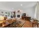 Bright living room features a painted brick fireplace, hardwood floors, and French doors to the outside at 7804 Tylerton Dr, Raleigh, NC 27613