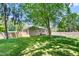 Large backyard with lawn, trees, and a house view at 827 Loop Rd Rd, Burlington, NC 27217
