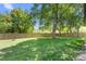 Lush backyard featuring a well-maintained lawn and mature trees at 827 Loop Rd Rd, Burlington, NC 27217