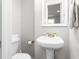 Half bathroom features a pedestal sink and neutral finishes at 827 Loop Rd Rd, Burlington, NC 27217