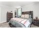 A spacious bedroom featuring a wooden headboard, natural light, and wood furnishings at 827 Loop Rd Rd, Burlington, NC 27217