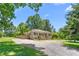 Charming home featuring a gravel driveway, two wooden decks, and light gray brick at 827 Loop Rd Rd, Burlington, NC 27217