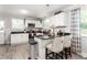Well-lit kitchen showcasing white cabinets, sleek black countertops, and a functional breakfast bar at 827 Loop Rd Rd, Burlington, NC 27217