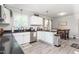 Open concept kitchen featuring white cabinets, stainless steel appliances and an adjacent dining area at 827 Loop Rd Rd, Burlington, NC 27217