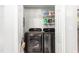 Modern laundry room featuring a pair of new black stainless steel washing machines and shelving for storage at 827 Loop Rd Rd, Burlington, NC 27217