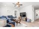 Cozy living room with a comfortable blue sectional sofa, ceiling fan, and modern decor at 827 Loop Rd Rd, Burlington, NC 27217