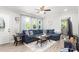 Inviting living room featuring a blue sectional sofa, large windows, and stylish decor at 827 Loop Rd Rd, Burlington, NC 27217