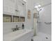 Bright bathroom with white tile shower, sink vanity, mirrored cabinet, and woven basket storage at 8513 Applecross Cir, Apex, NC 27539