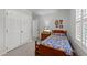 Cozy bedroom with carpet, built in closet and small bedside table with lamp at 8513 Applecross Cir, Apex, NC 27539