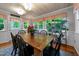 Dining room featuring hardwood floors, painted wood ceiling and several windows at 8513 Applecross Cir, Apex, NC 27539