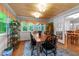 Dining room featuring hardwood floors, beamed wood ceilings, and large windows at 8513 Applecross Cir, Apex, NC 27539