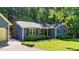 A charming home featuring blue siding, black shutters, a brick chimney, and a well-manicured lawn at 8513 Applecross Cir, Apex, NC 27539