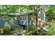 Back of home featuring lush landscaped backyard, deck, and fence at 8513 Applecross Cir, Apex, NC 27539