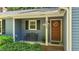 Inviting front porch features a bench, address numbers, and a decorative wreath on the front door at 8513 Applecross Cir, Apex, NC 27539