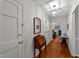 Hallway showcasing hardwood floors, neutral walls, and stylish decorations leading to the living room at 8513 Applecross Cir, Apex, NC 27539