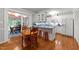 Open kitchen featuring white cabinets, blue countertops, hardwood floors and adjacent breakfast nook at 8513 Applecross Cir, Apex, NC 27539