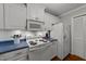 Kitchen featuring white cabinetry, blue countertops, hardwood floors and stainless steel appliances at 8513 Applecross Cir, Apex, NC 27539