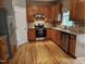 Functional kitchen featuring wood cabinets, granite countertops, and stainless steel appliances at 9009 Miranda Dr, Raleigh, NC 27617