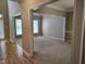 Bright and airy living room with neutral carpet and a large opening to an adjacent room at 9009 Miranda Dr, Raleigh, NC 27617