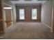 Spacious living room featuring neutral-toned walls and carpet with two windows providing natural light at 9009 Miranda Dr, Raleigh, NC 27617