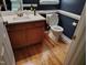 Charming powder room with white countertop and oak cabinets at 9009 Miranda Dr, Raleigh, NC 27617