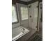 Stylish walk-in shower with glass door and subway tile at 9009 Miranda Dr, Raleigh, NC 27617