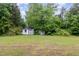 Property includes two sheds and a sprawling lawn surrounded by trees at 1012 Roxboro St, Haw River, NC 27258