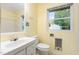 Bright bathroom featuring a window and standard fixtures at 1012 Roxboro St, Haw River, NC 27258