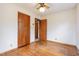 Well-lit bedroom with wood floors, ceiling fan, and convenient closet access at 1012 Roxboro St, Haw River, NC 27258
