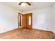Clean, bright bedroom features wood floors, closet, and a ceiling fan at 1012 Roxboro St, Haw River, NC 27258