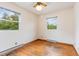 This bedroom has two windows that provide great natural light and wood flooring at 1012 Roxboro St, Haw River, NC 27258