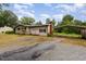 Ranch home with front ramp, mature trees, gravel drive, and carport at 1012 Roxboro St, Haw River, NC 27258